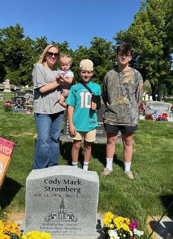 <p>Courtesy of Jason and Kirsten Clawson</p> Kirsten Clawson visiting her late husband's grave with her daughter and stepsons.
