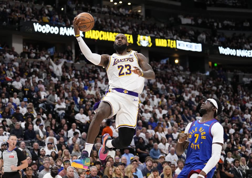 Los Angeles Lakers forward LeBron James (23) goes up to shoot against Denver Nuggets guard Reggie Jackson (7) during the first half in Game 1 of an NBA basketball first-round playoff series Saturday, April 20, 2024, in Denver. (AP Photo/Jack Dempsey)