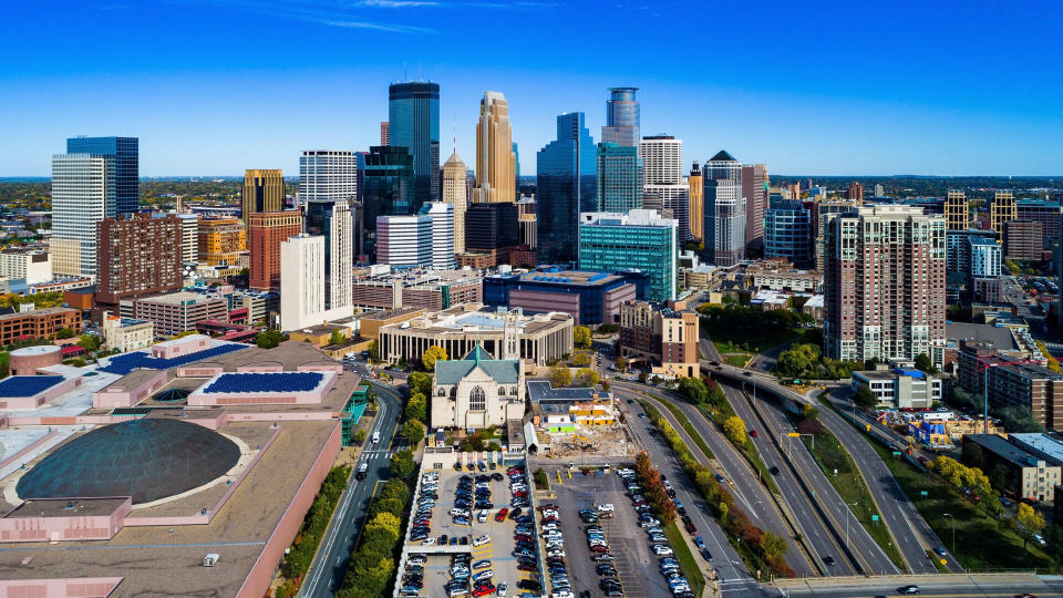 Downtown Minneapolis skyline aerial view with the Minneapolis Convention Center on the left and MN 65 highway on the right.