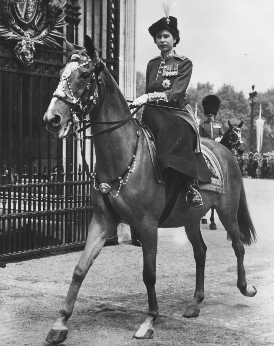 <p>The then-Princess Elizabeth as Colonel of the Grenadier Guards in a ceremonial dress. She appears on behalf of her father during the ceremony held in honour of the King's birthday. (Getty Images)</p> 