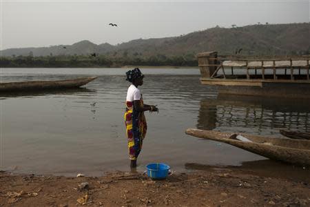 A woman cleans freshly caught fish on the shores of the Obangui river in the district of Wango of the capital Bangui March 6, 2014. REUTERS/Siegfried Modola