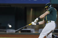 Oakland Athletics' Matt Chapman connects for an RBI single during the seventh inning of a baseball game against the Texas Rangers, Wednesday, June 23, 2021, in Arlington, Texas. (AP Photo/Brandon Wade)