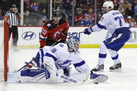 Tampa Bay Lightning goaltender Andrei Vasilevskiy makes a save in front of New Jersey Devils center Michael McLeod (20) during the second period of an NHL hockey game Tuesday, March 14, 2023, in Newark, N.J. (AP Photo/Adam Hunger)