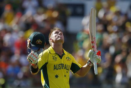 Australia's batsman David Warner looks to the sky as he acknowledges his century during their Cricket World Cup match against Afghanistan in Perth March 4, 2015. REUTERS/David Gray