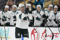 San Jose Sharks center Patrick Marleau (12) motions to the crowd during a break to mark his passing Gordie Howe for most NHL games played in the first period of an NHL hockey game Monday, April 19, 2021, in Las Vegas. (AP Photo/John Locher)