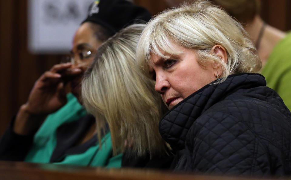 June Steenkamp, center, mother of Reeva Steenkamp, bows her head while listening to forensic evidence in Pretoria, South Africa, Thursday, April 17, 2014 at the murder trial of Oscar Pistorius. One of Oscar Pistorius’ defense experts was grilled by the chief prosecutor for the second day at the Olympic runner’s murder trial Thursday, with forensic specialist Roger Dixon’s expertise and professionalism in conducting various tests regarding Reeva Steenkamp’s shooting death again sternly questioned. Pistorius is charged with premeditated murder for shooting Steenkamp multiple times on Feb. 14, 2013. Prosecutors say that he killed Steenkamp after a fight. The trial was adjourned until May 5. (AP Photo/Themba Hadebe, Pool)