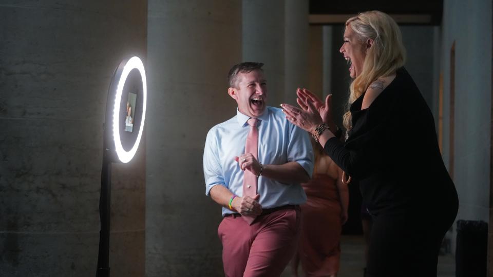 Ryan Donahue and Anne Wilson joke around at a photo station at the Unity Prom, an adults-only, LGBTQ-focused prom party presented by the Columbus Lesbian & Gay Softball Association and benefiting Kaleidoscope Youth Center, which took place at the Ohio Statehouse Saturday, April 15, 2023.