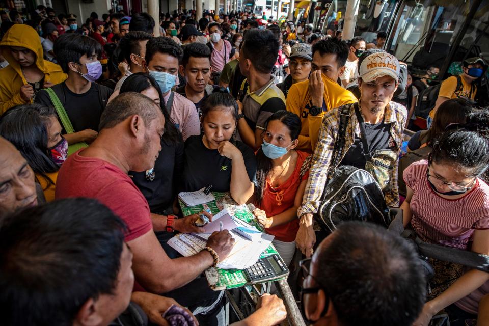Filipinos hoping to leave Manila before it is placed on lockdown flock at a bus station on March 13, 2020 in Quezon city, Metro Manila, Philippines.