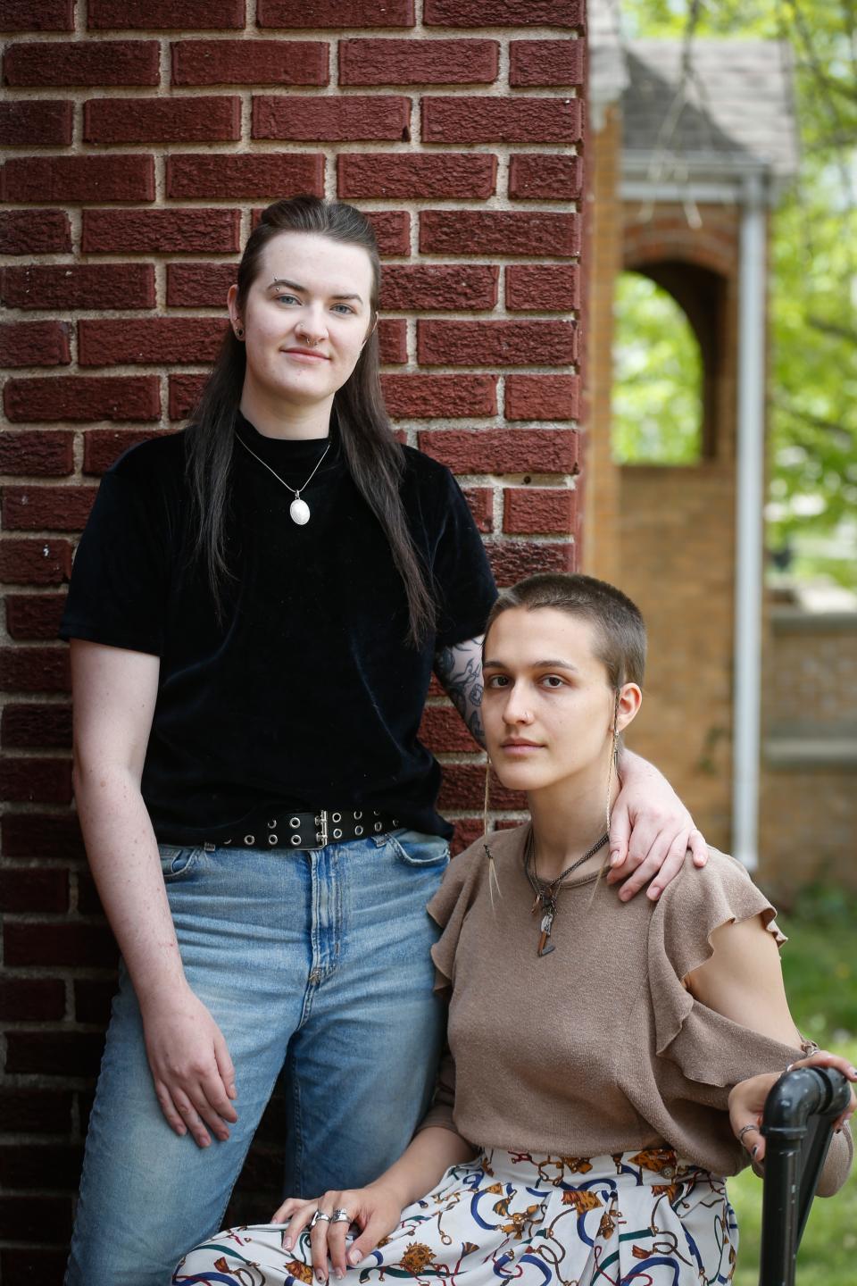 Andy Rodenbusch, left, and Nathalie "Hal" Dempsey pose for a portrait outside of their home in Springfield on Friday, April 21, 2023. Rodenbusch, Dempsey and their third partner are raising money to move out of Missouri following Attorney General Andrew Bailey's emergency rule on gender-affirming care.