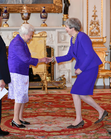 Britain's Queen Elizabeth II is joined by Prime Minister Theresa May at a reception to mark the fiftieth anniversary of the investiture of the Prince of Wales at Buckingham Palace in London, Britain March 5, 2019. Dominic Lipinski/Pool via REUTERS
