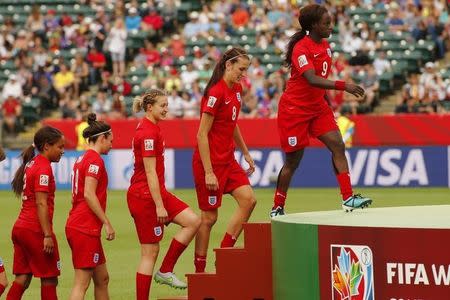 Jul 4, 2015; Edmonton, Alberta, CAN; England players climb a podium to receive awards after defeating Germany in the third place match of the FIFA 2015 Women's World Cup at Commonwealth Stadium. England defeated Germany 1-0 in extra time. Erich Schlegel-USA TODAY Sports