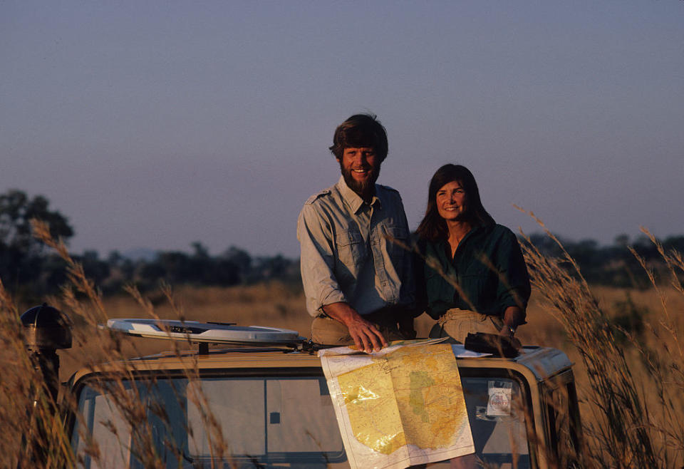 owens and her husband standing on a jeep outside