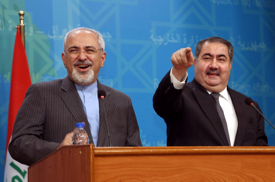 Iraqi Foreign Minister Hoshyar Zebari, right, gestures during a joint press conference with his Iranian counterpart Mohammad Javed Zarif in Baghdad, Iraq, Tuesday, Jan. 14, 2014. (AP Photo/Khalid Mohammed)