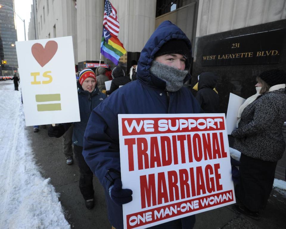 Protestors demonstrate outside Federal Courthouse before a trial that could overturn Michigan's ban on gay marriage in Detroit on Monday, March 3, 2014 in Detroit. Lisa Brown of Oakland County, the elected clerk of a Detroit-area county says she'll follow the orders of a judge when it comes to same-sex marriage, not Michigan's attorney general. Brown was asked about an email last fall from the attorney general's office, which warned county clerks not to issue marriage licenses to same-sex couples, even if a judge threw out the ban. Michigan voters banned gay marriage in 2004. In a lawsuit, Detroit-area nurses April DeBoer and Jayne Rowse say that violates the U.S. Constitution. (AP Photo/Detroit News, David Coates) DETROIT FREE PRESS OUT; HUFFINGTON POST OUT