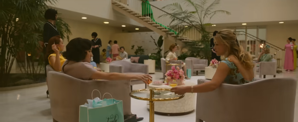 Woman having a conversation while sitting in chairs in a large lobby