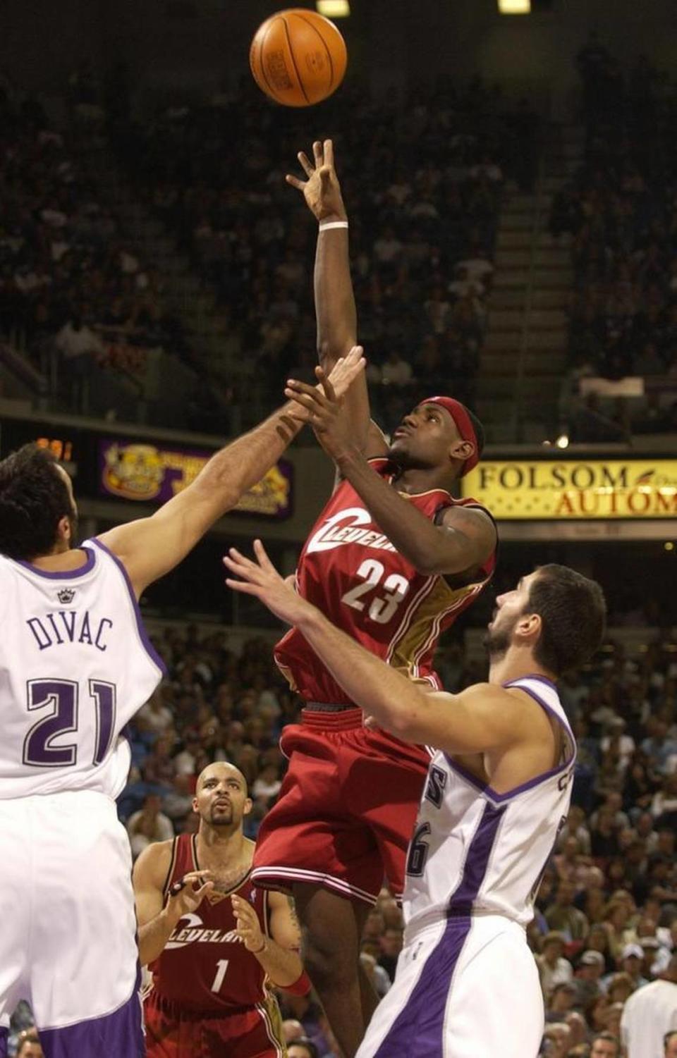 LeBron James of the Cleveland Cavaliers puts up a shot against Vlade Divac of the Sacramento Kings during an NBA basketball game on Oct. 29, 2003 at Arco Arena in Sacramento.