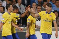 Arsenal Players celebrate after Theo Walcott scored against Olympique Marseille during their Group F Champions League soccer match at the Velodrome stadium in Marseille, September 18, 2013. REUTERS/Jean-Paul Pelissier (FRANCE - Tags: SPORT SOCCER)