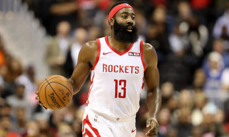 James Harden wearing a headband while dribbling the ball.