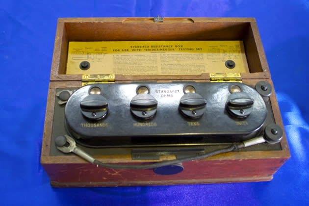 This wooden cased Bridge-Megger testing kit was used to find out the insulation resistance of an electrical circuit. It was important to test circuits to find out if they were faulty, damaged or had damp fittings.