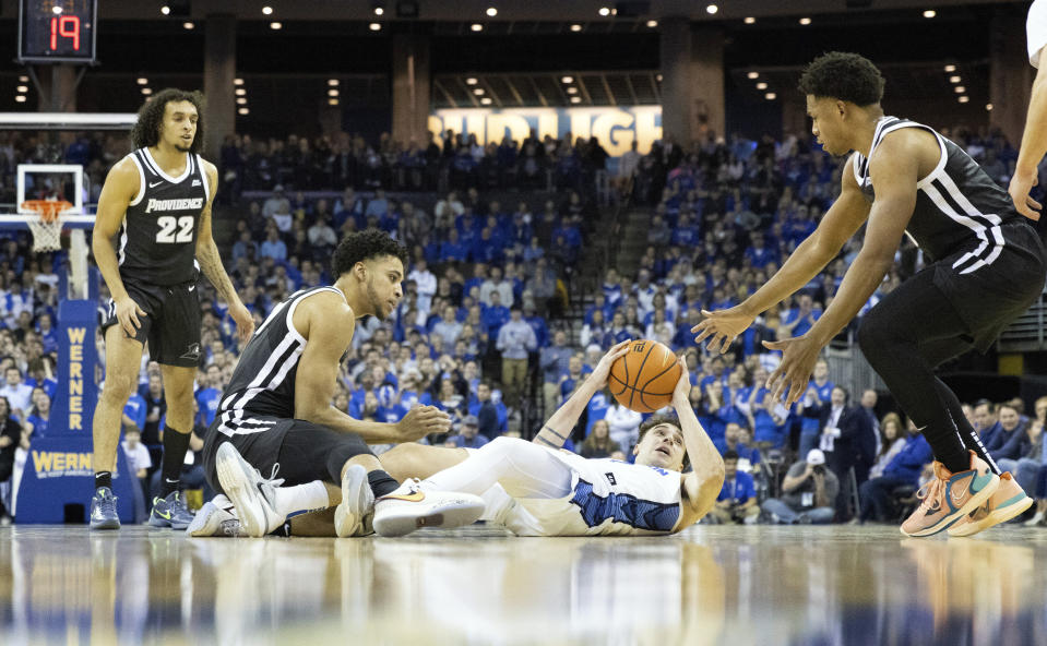 Creighton's Francisco Farabello, second from right, scrambles to save a loose ball against Providence's Devin Carter, from left, Clifton Moore and Noah Locke during the first half of an NCAA college basketball game on Saturday, Jan. 14, 2023, in Omaha, Neb. (AP Photo/Rebecca S. Gratz)