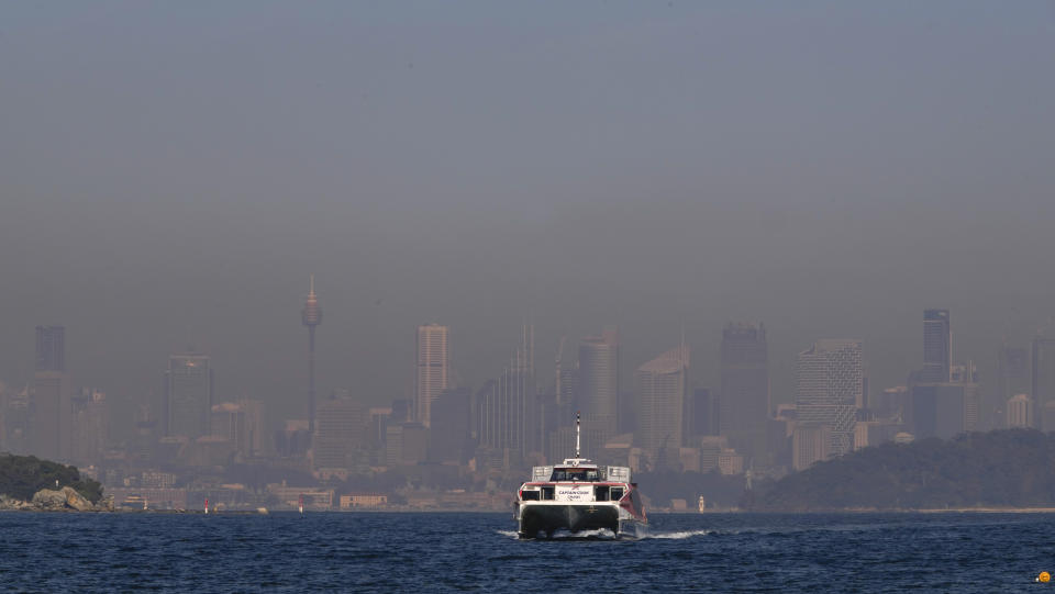A passenger ferry arrives at a wharf in Watsons Bay as a thick a blanket of smoke hangs over parts of the Sydney following New South Wales Rural Fire Service (RFS) hazard reduction burns in the past week, Thursday, Sept. 14, 2023. The NSW Rural Fire Service and National Parks and Wildlife Service are burning over 600 hectares around Sydney before an expected hot weekend that will begin a run of high temperatures and increased fire risk. (AP Photo/Mark Baker)