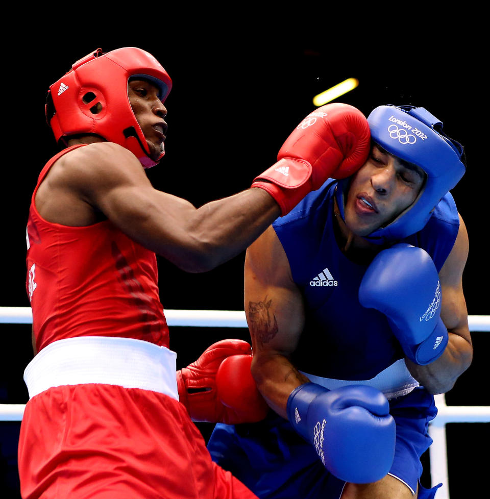 LONDON, ENGLAND - AUGUST 04: Julio la Cruz Peraza of Cuba (L) in action with Ihab Almatbouli of Jordan during the Men's Light Heavy (64kg) Boxing on Day 8 of the London 2012 Olympic Games at ExCeL on August 4, 2012 in London, England. (Photo by Scott Heavey/Getty Images)
