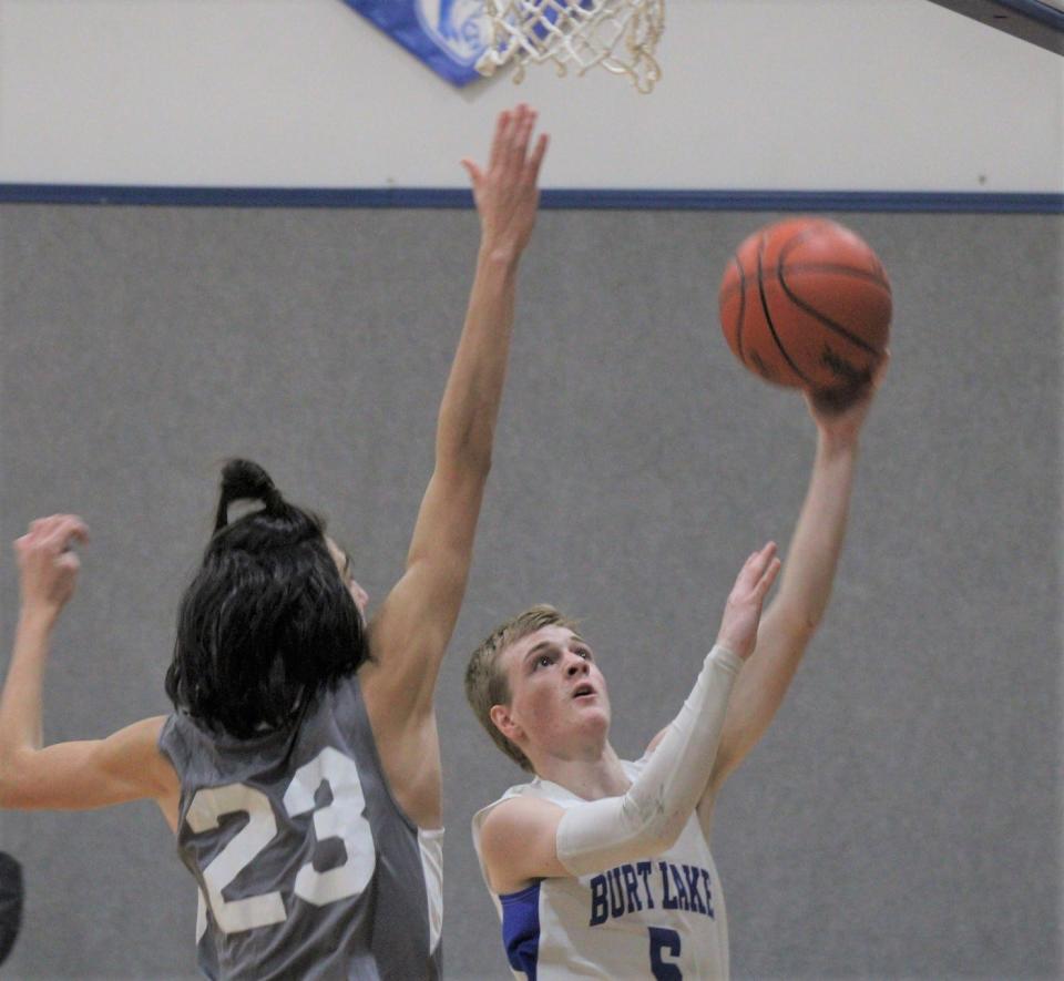 Senior guard Josiah Brabson (right) scored a team-high 28 points for the Burt Lake NMCA boys, who captured a season-opening win at Forest Area on Tuesday.