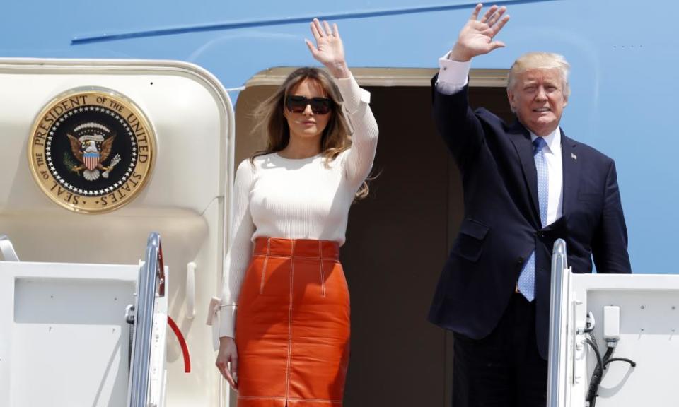 Donald and Melania Trump wave as they board Air Force One at Andrews Air Force Base in Maryland Friday.