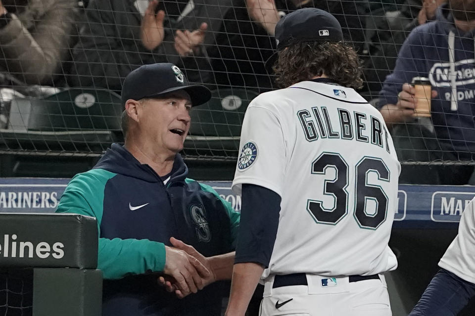 Seattle Mariners starting pitcher Logan Gilbert shakes hands with manager Scott Servais, left, after Gilbert pitched the seventh inning of a baseball game against the Houston Astros, Saturday, May 28, 2022, in Seattle. (AP Photo/Ted S. Warren)