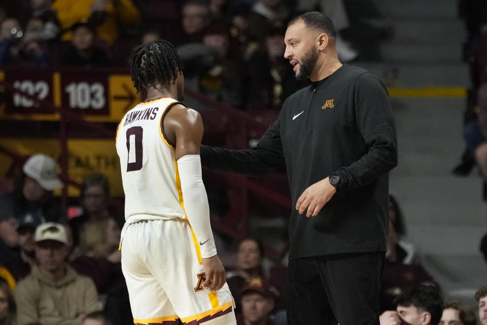 Minnesota guard Elijah Hawkins (0) talks with head coach Ben Johnson during the first half of an NCAA college basketball game against USC Upstate, Saturday, Nov. 18, 2023, in Minneapolis. (AP Photo/Abbie Parr)