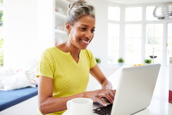 Smiling older woman at laptop