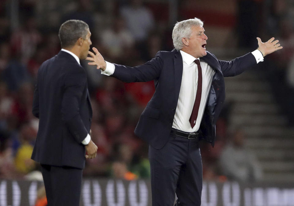 Southampton manager Mark Hughes, right, gestures on the touchline as Brighton & Hove Albion manager Chris Hughton looks on, during their English Premier League soccer match at St Mary's in Southampton, England, Monday Sept. 17, 2018. (John Walton/PA via AP)
