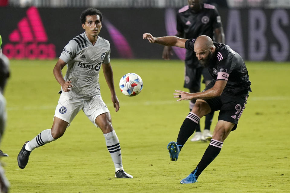 Inter Miami forward Gonzalo Higuain (9) kicks the ball as Montreal midfielder Ahmed Hamdi watches during the first half of an MLS soccer match Wednesday, May 12, 2021, in Fort Lauderdale, Fla. (AP Photo/Lynne Sladky)