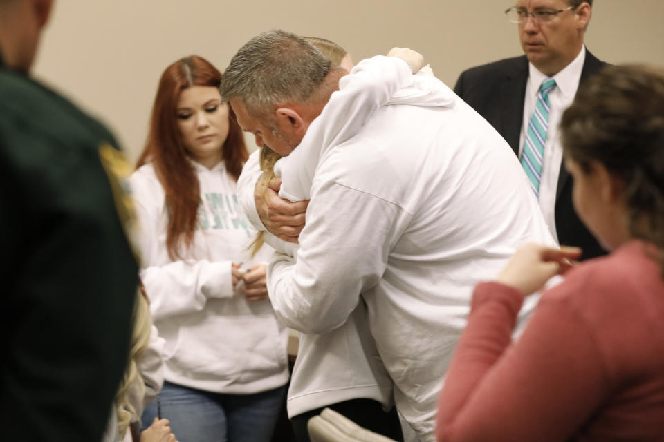 Forrest Bailey, the father of victim Tristyn Bailey, gets a hug from a family member at the end of the sentencing hearing for Aiden Fucci, Friday, March 24, 2023. in St. Augustine, Fla. A Florida judge sentenced Fucci, 16, to life in prison on Friday for fatally stabbing 13-year-old classmate Tristyn Bailey on Mother's Day in 2021. Fucci, who pleaded guilty just before his trial was set to start in February, was not eligible for the death penalty. (Bob Self/The Florida Times-Union via AP)