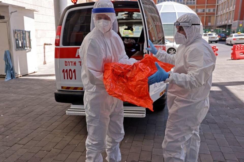 Medics with the Magen David Adom transfer the belongings of a Coronavirus patient to the Hadassah Ein Kerem Hospital in Jerusalem, due to full capacity in other hospitals following a sharp increase in the number of coronavirus infections in Israel.