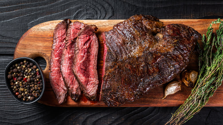 sliced hanger steak on board