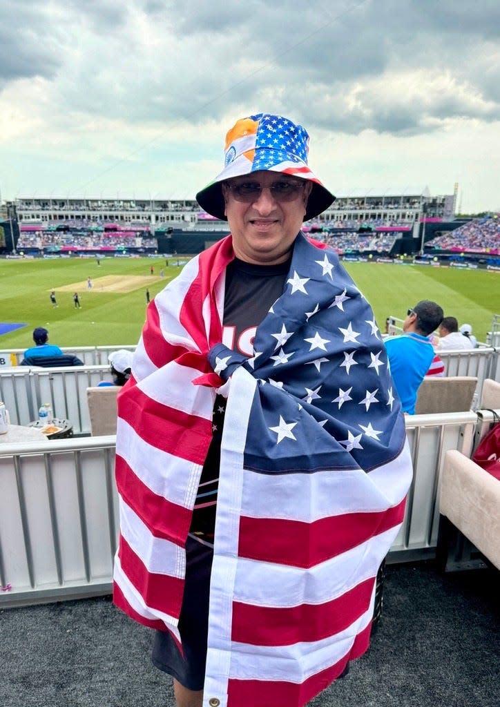 Vinay Manhass, a cricket buff, traveled from North Carolina especially for the game, wearing a hat that had the flags of the U.S. and India on it and carrying the U.S. flag during the India vs. USA match at the Nassau County International Cricket Stadium on June 12, 2024.