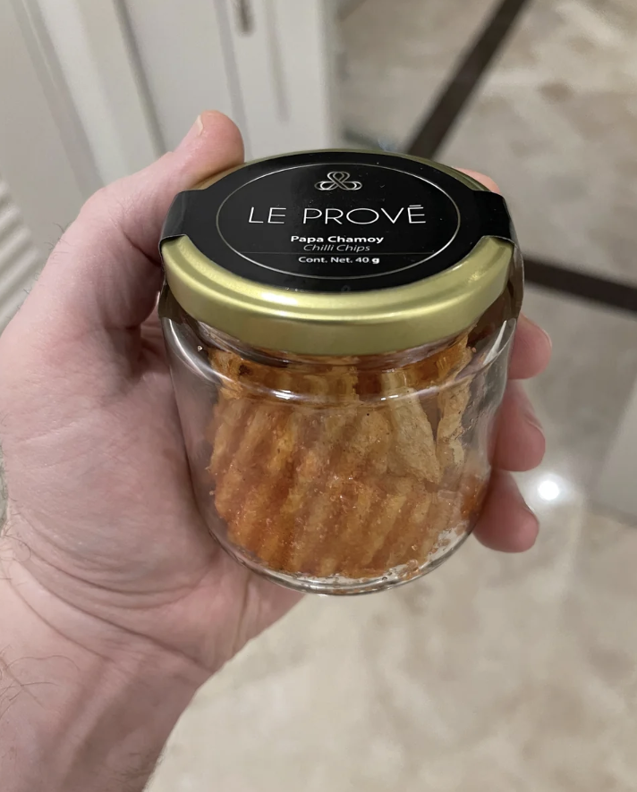 Person holding a jar of Le Prove Papas-Cramberry snacks