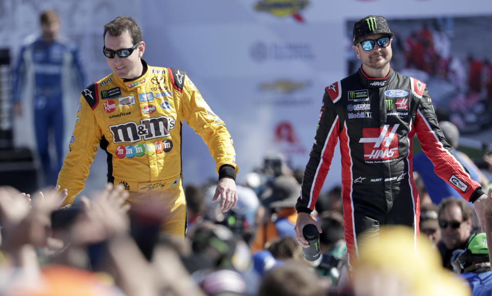 FILE - In this Feb. 18, 2018, file photo, Kyle Busch, left, and Kurt Busch, right, greet fans as they are introduced before a NASCAR Daytona 500 Cup Series auto race at Daytona International Speedway in Daytona Beach, Fla. The Busch family hobby came full circle at Las Vegas Motor Speedway, where Kurt finally won for the first time in his career Sunday, Sept. 27, 2020. The victory came about 24 hours after his nephew, Brexton Busch, won his first race at a track in North Carolina. The 5-year-old son of reigning Cup champion Kyle is being developed by Tom Busch, who molded his own two sons into NASCAR champions. (AP Photo/John Raoux, File)