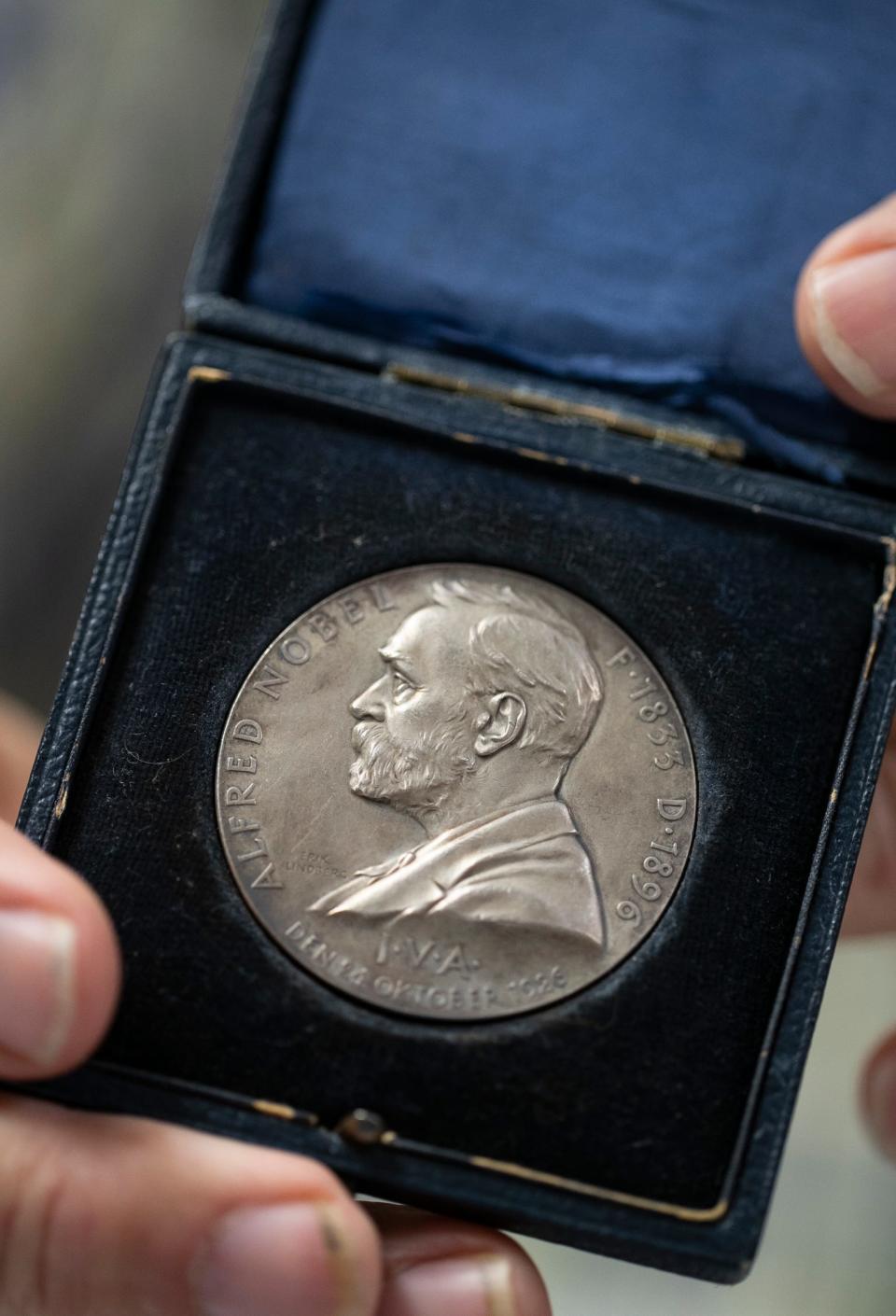 Gary E. Lewis displays a 1926 Nobel Award in chemistry judge's silver medal. Lewis, an expert numismatist, and former president of the Cape Coral and Fort Myers coin clubs, makes presentations to organizations and offers appraisal services.