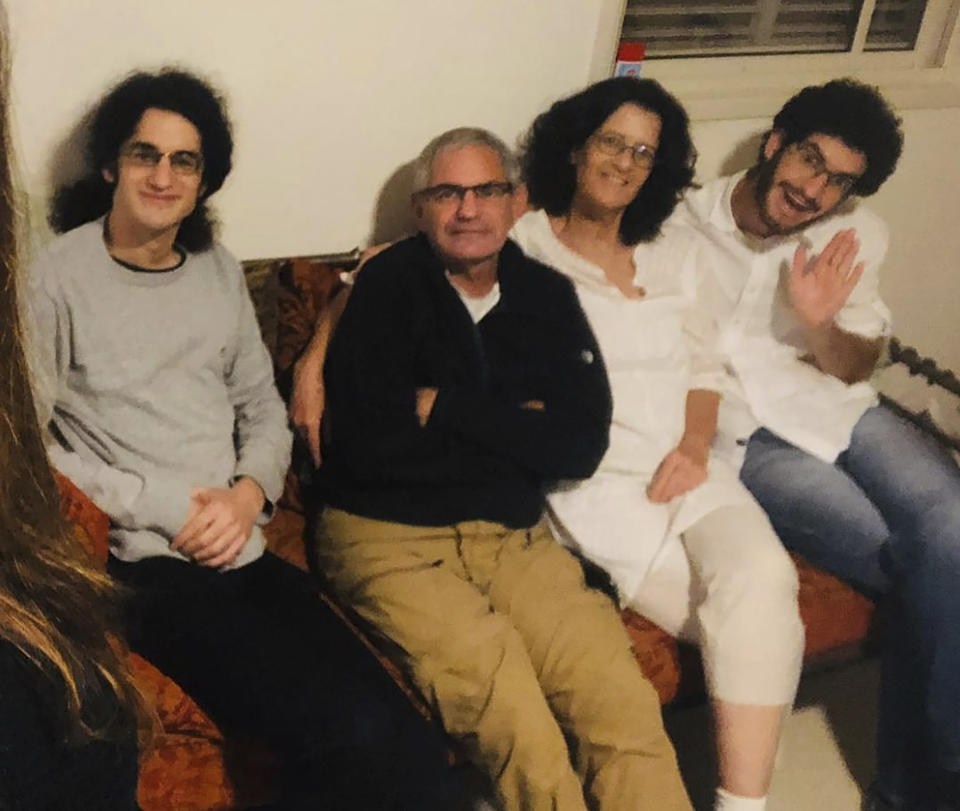 This undated photo released Wednesday Oct. 11, 2023 by Nadav Kipnis, shows him, at right, sitting with his family, from left, his brother Yotam Kipnis, his father Eviatar Moshe Kipnis 65 and his mother Lilach Lea Havron 60. Eviatar Moshe Kipnis and Lilach Lea Havron are among the estimated 150 people believed held by Hamas in Gaza following the militant group's stunning incursion in Israel on Saturday. The couple and their health care aide were last heard from Saturday morning, sheltering in their safe room, after militants had begun storming Be'eri, where at least 100 people were later found dead. (Kipnis Family via AP)