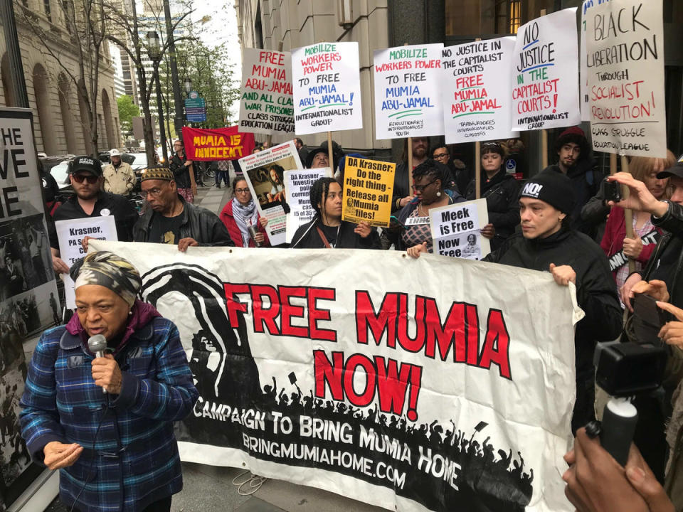 <span class="icon icon--xs icon__camera">  </span> <span class="credit font--s-m upper black"> <b>JESSICA GRIFFIN / Staff Photographer</b> </span> <div class="caption space-half--right font--s-m gray--med db">Supporters of Mumia Abu-Jamal, convicted of killing a city police officer, gather outside the Criminal Justice Center at 13th and Filbert Streets in Center City Philadelphia on Monday morning.</div>