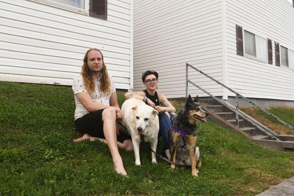 James Weimer, left, and Julie Mullins with their dogs outside their apartment at Rand at Tillery, formerly Tanglewood Apartments. The couple are brainstorming ways to make more money to cope with rising rents.