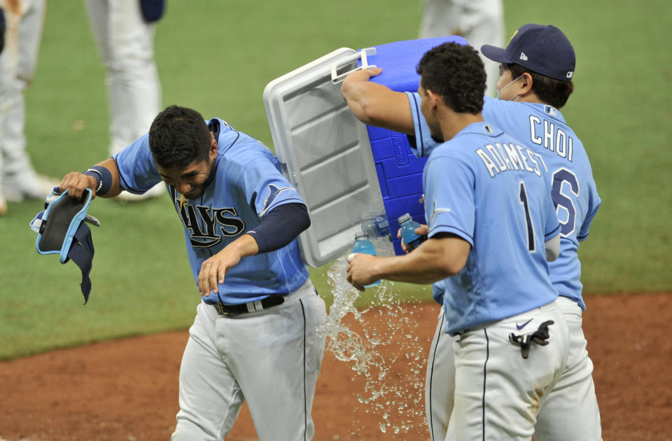 From left to right, Tampa Bay Rays' Michael Perez, Willy Adames and Ji-Man Choi celebrate a win over the New York Yankees in a baseball game Sunday, Aug. 9, 2020, in St. Petersburg, Fla. (AP Photo/Steve Nesius)