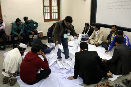 Presiding officers count votes at a voting center after the session has ended in Dhaka, Bangladesh, December 30, 2018. REUTERS/Mohammad Ponir Hossain