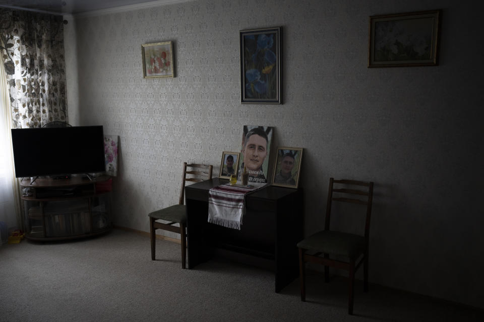 Pictures of Anastasiia Okhrimenko's late husband Yurii Stiahliuk sit in the living room of his parent's apartment where Anastasiia lives with her son Vanya in Bucha, Ukraine, Tuesday, Jan. 24, 2023. (AP Photo/Daniel Cole)