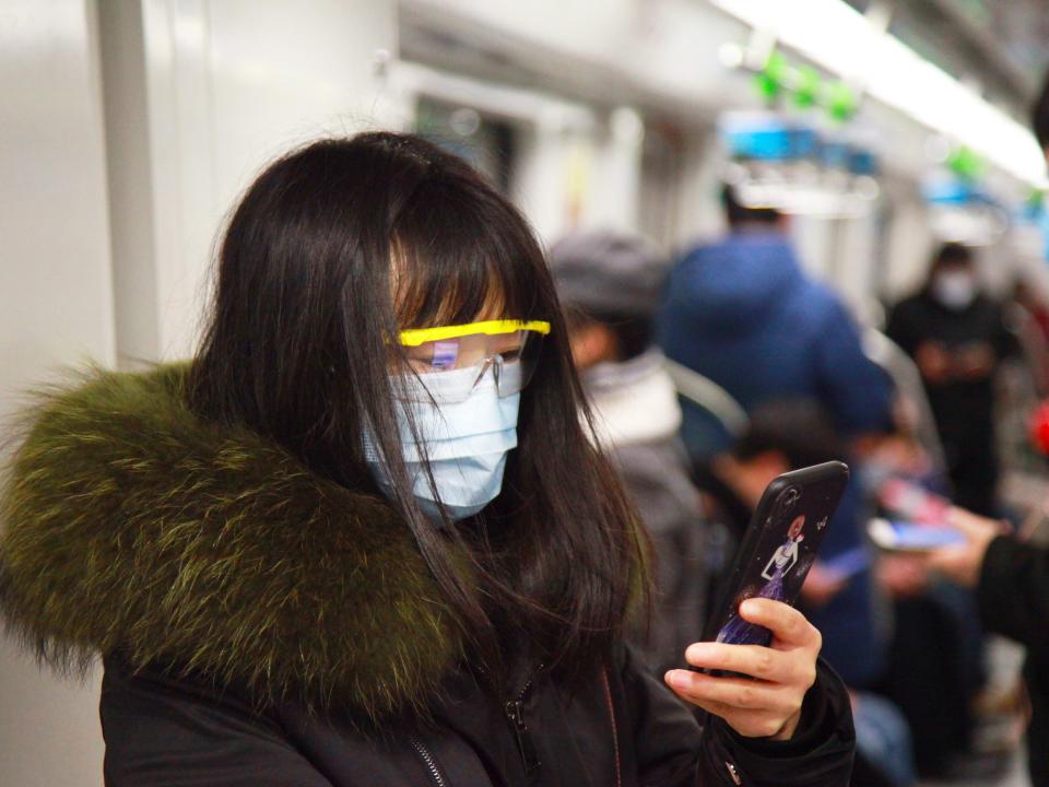 woman coronavirus phone mask train code