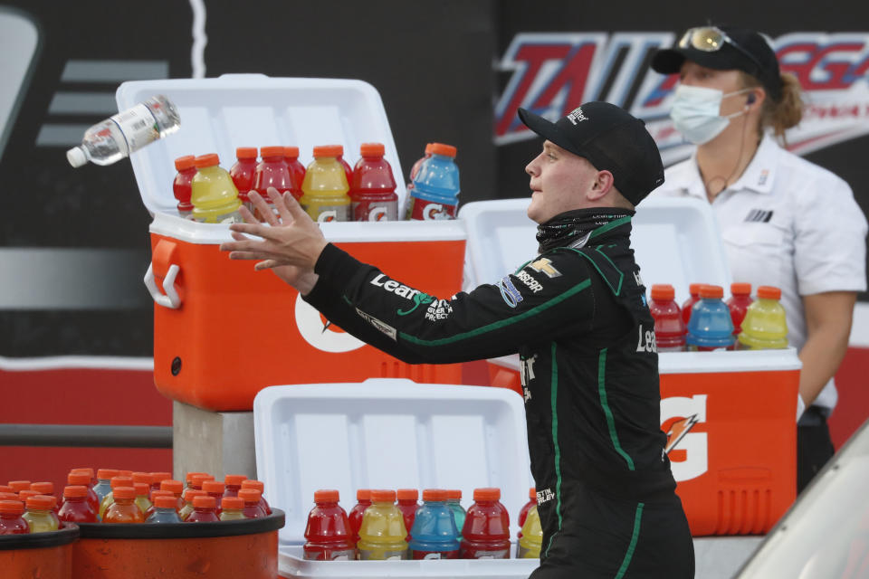 Justin Haley reaches to catch a bottle of water as he celebrates in Victory Lane after winning a NASCAR Xfinity auto race at Talladega Superspeedway in Talladega Ala., Saturday, June 20, 2020. (AP Photo/John Bazemore)