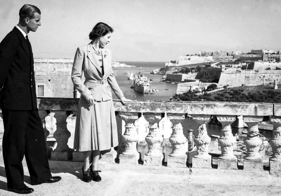 Princess Elizabeth and her husband Prince Philip, the Duke of Edinburgh, look out over the harbor and city of Valetta, Malta, on Nov. 23, 1949. (Max Desfors / AP file)