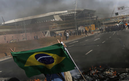 A member of Brazil's Homeless Workers' Movement blocks a road during a protest in front of Sao Paulo's World Cup stadium in this May 15, 2014 file photo. REUTERS/Nacho Doce/Files